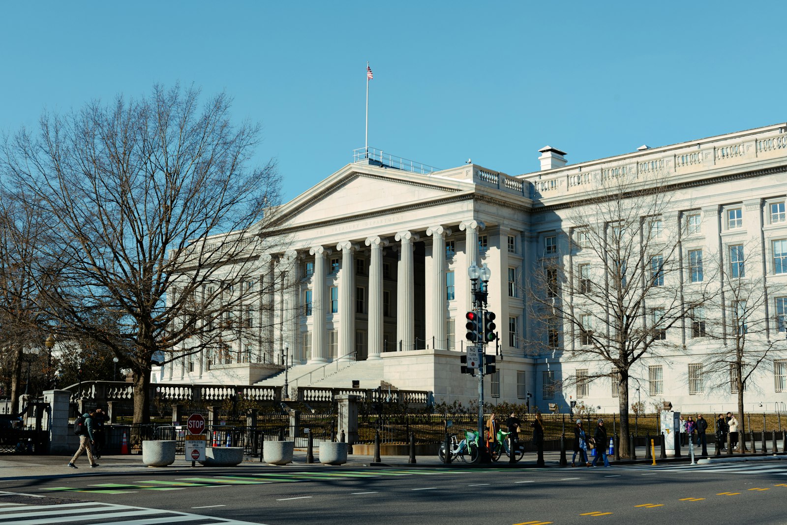 a large white building with columns and a flag on top